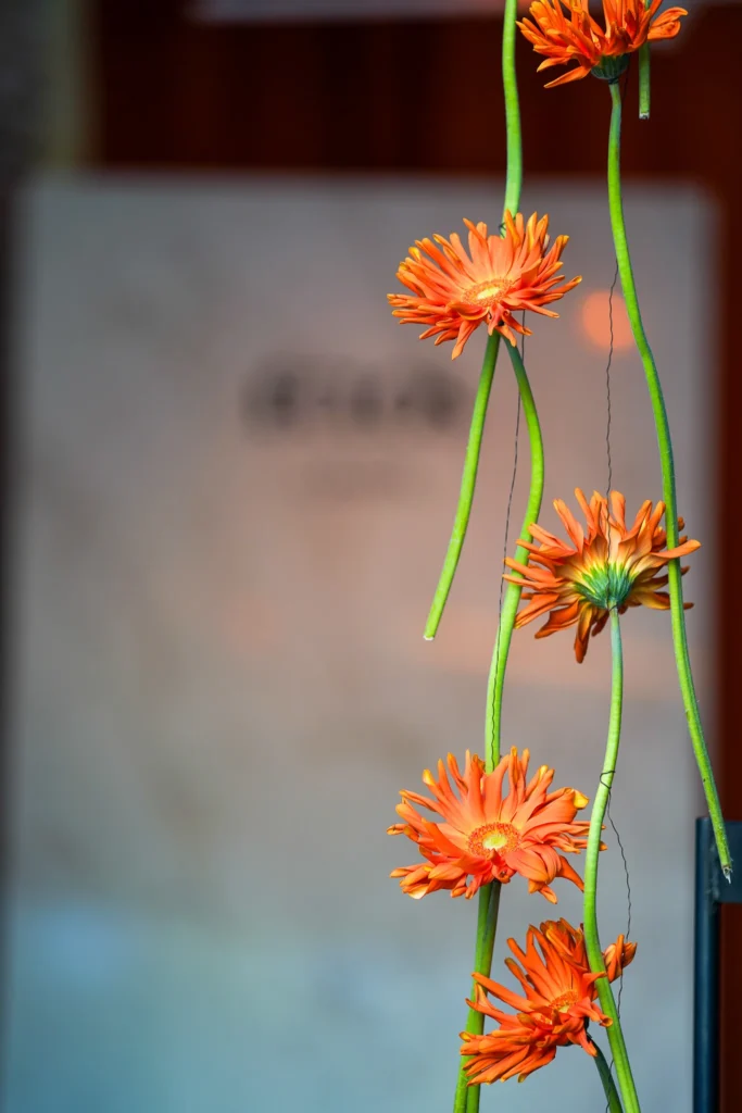 Instalación floral naranja junto a la superficie Eclos